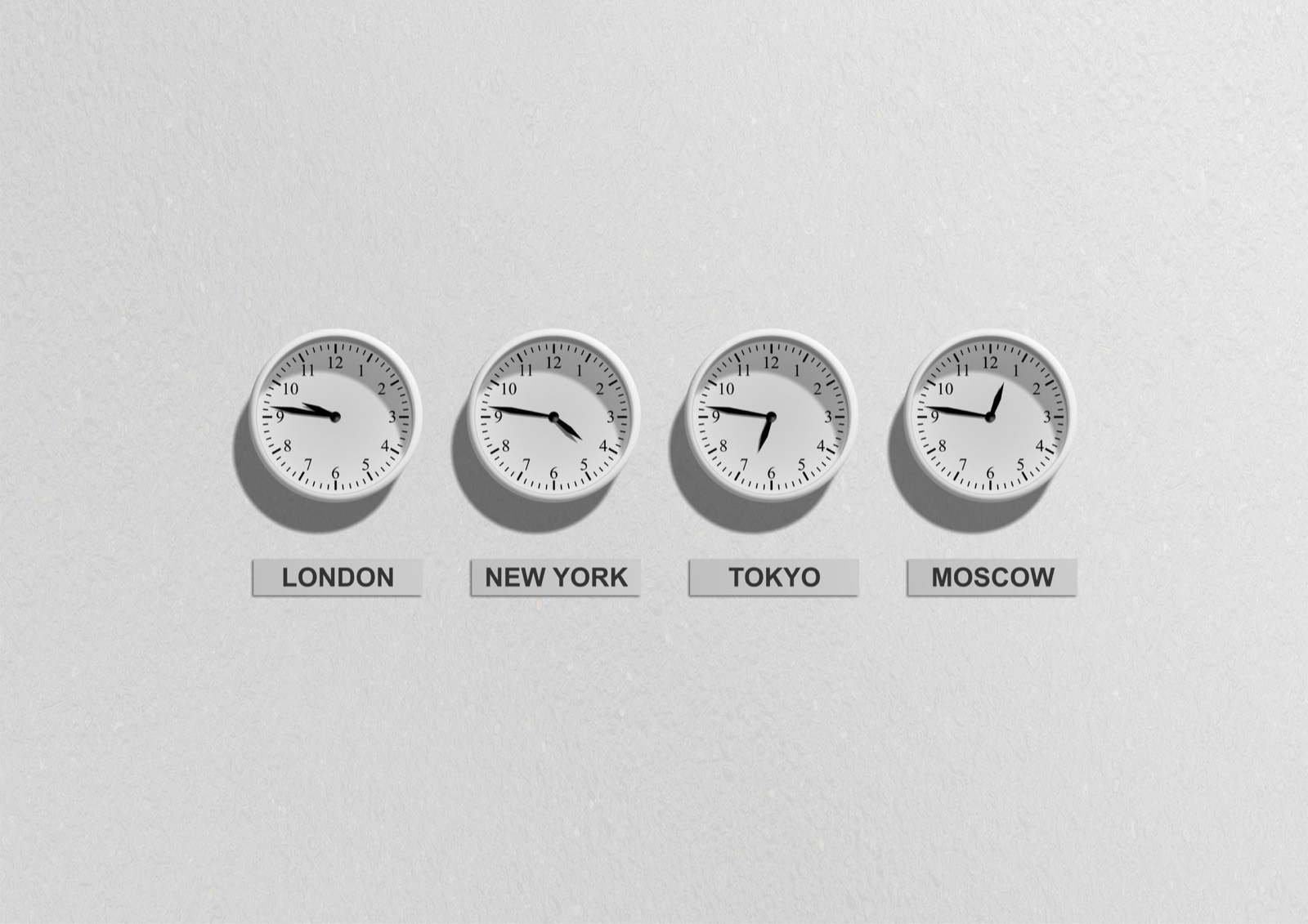 Wall clocks for four time zones